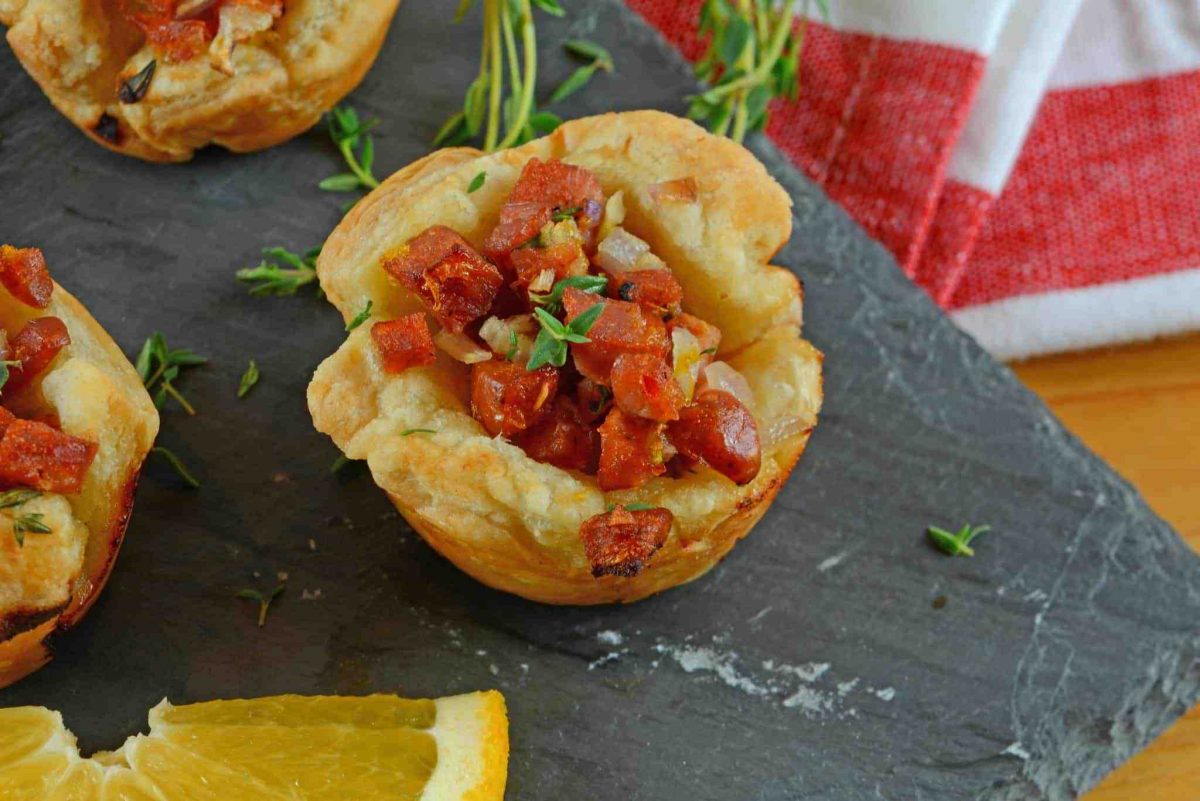 Citrus Sausage Cups are an easy appetizer using smoky andouille sausage, orange zest, sweet onion and fresh thyme in a puff pastry cup. #puffpastryappetizers #puffpastrycups www.savoryexperiments.com