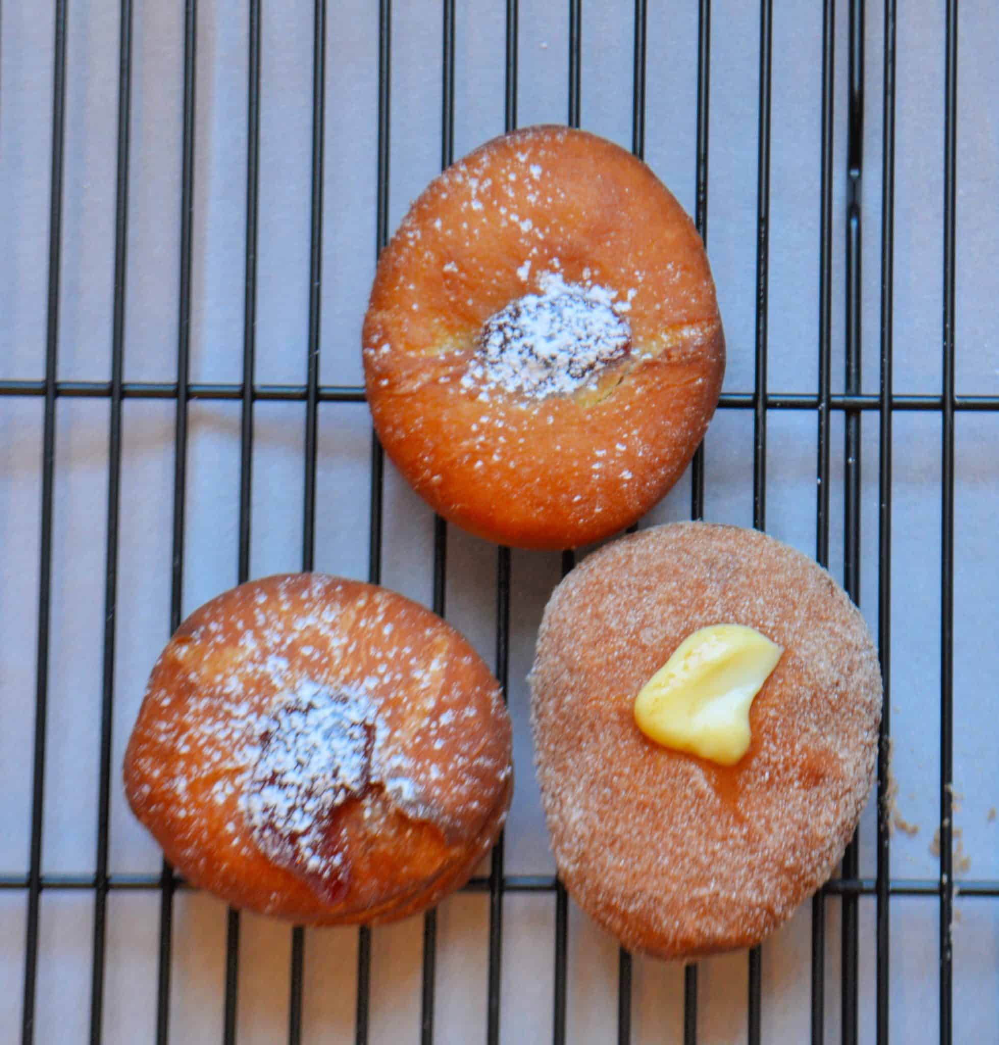 Sufganiyot Stuffed Donuts let you prepare warm & fresh strawberry jelly & vanilla custard stuffed donuts at home! Light & fluffy dough with a hint of sugar! #donutrecipe #stuffeddonuts #easysufganiyotrecipe www.savoryexperiments.com