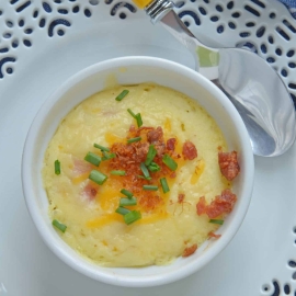This Ham and Cheese Egg Soufflé recipe is perfect for breakfast or brunch, and great for a crowd! Made up of eggs, ham, cheddar cheese, bacon, and chives! #eggsoufflé #cheesesoufflé #soufflérecipe www.savoryexperiments.com