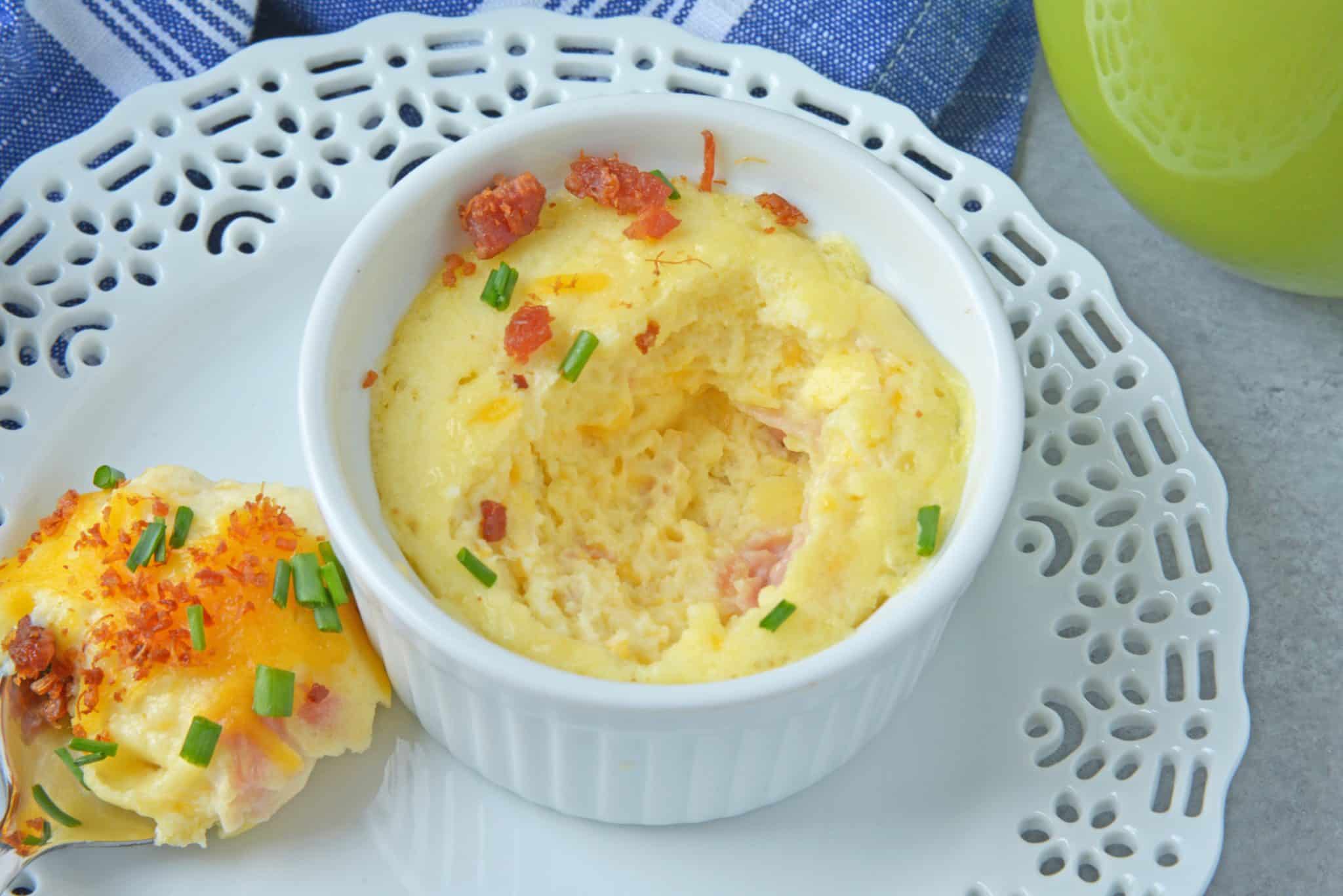 This Ham and Cheese Egg Soufflé recipe is perfect for breakfast or brunch, and great for a crowd! Made up of eggs, ham, cheddar cheese, bacon, and chives! #eggsoufflé #cheesesoufflé #soufflérecipe www.savoryexperiments.com