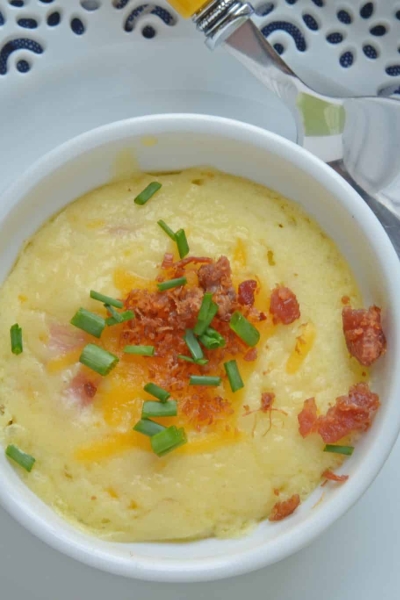 This Ham and Cheese Egg Soufflé recipe is perfect for breakfast or brunch, and great for a crowd! Made up of eggs, ham, cheddar cheese, bacon, and chives! #eggsoufflé #cheesesoufflé #soufflérecipe www.savoryexperiments.com
