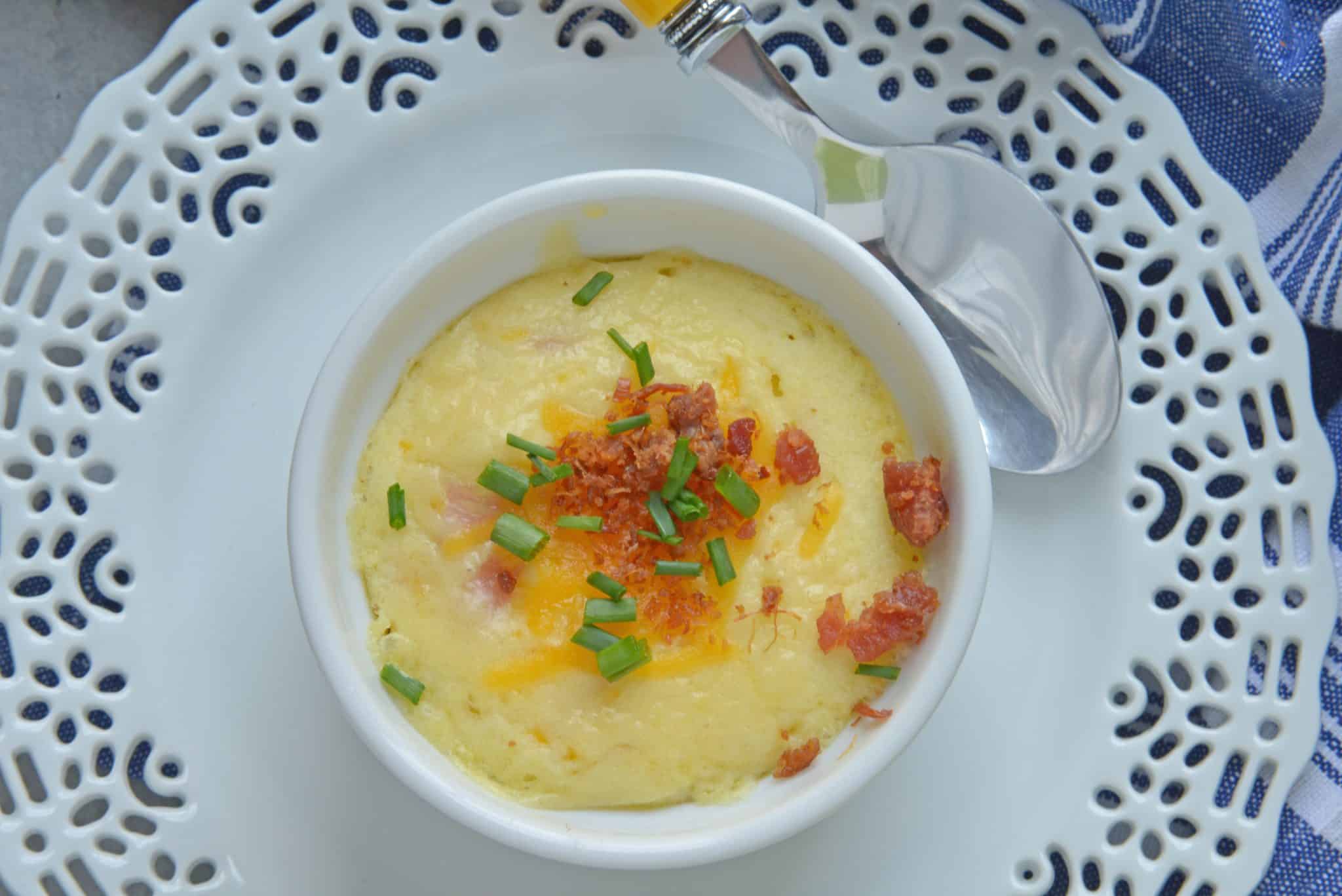 This Ham and Cheese Egg Soufflé recipe is perfect for breakfast or brunch, and great for a crowd! Made up of eggs, ham, cheddar cheese, bacon, and chives! #eggsoufflé #cheesesoufflé #soufflérecipe www.savoryexperiments.com