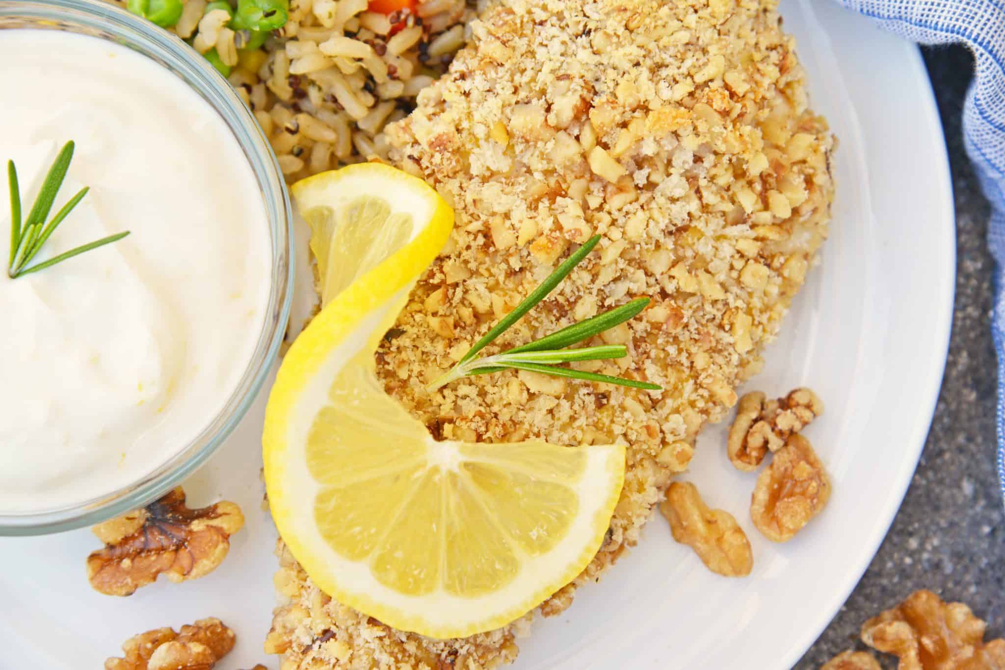 Walnut Crusted Chicken is a deliciously healthy, crunchy chicken with a cool dipping sauce! Made with chopped walnuts, panko bread crumbs, and fresh rosemary! #walnutcrustedchicken #rosemarychicken www.savoryexperiments.com