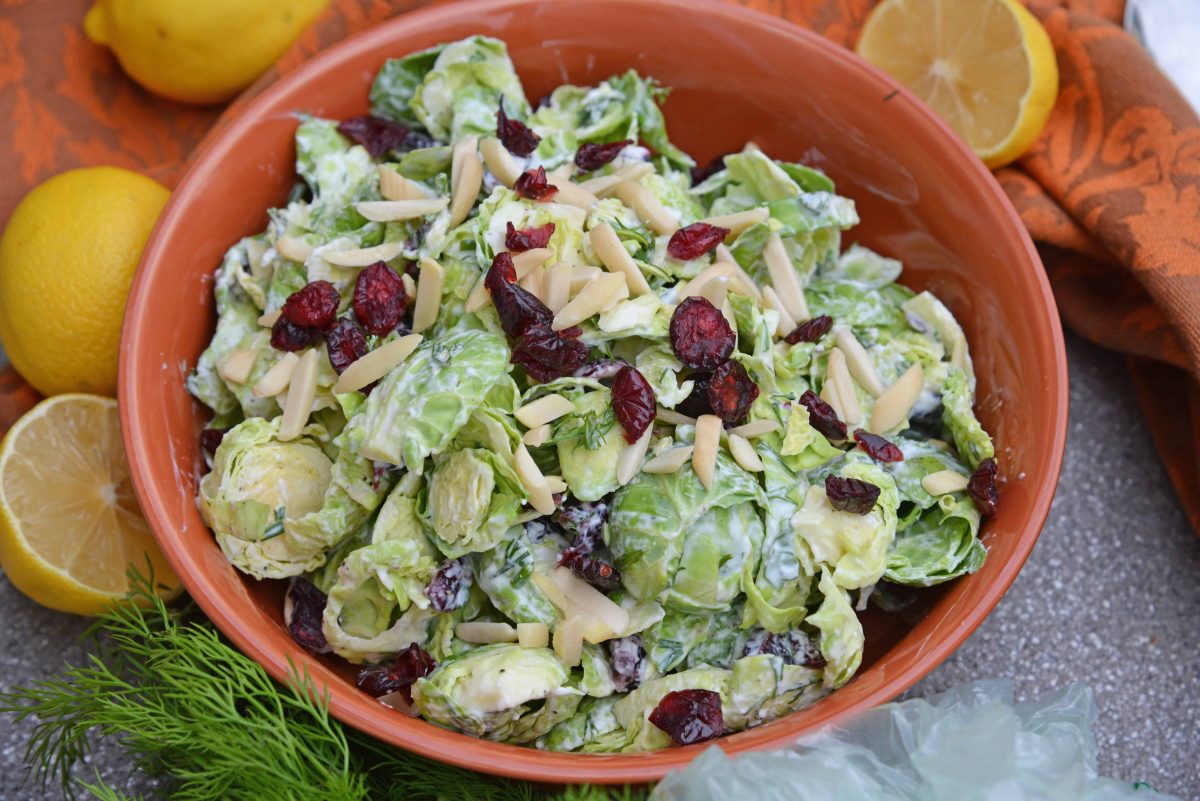 Cranberry Almond Brussel Sprout Slaw is a healthy and delicious way to eat raw brussels sprouts. Mixed with yogurt, dill, cranberry and almond, it is packed with flavor! #brusselsproutsrecipe #brusselsproutsalad www.savoryexperiments.com