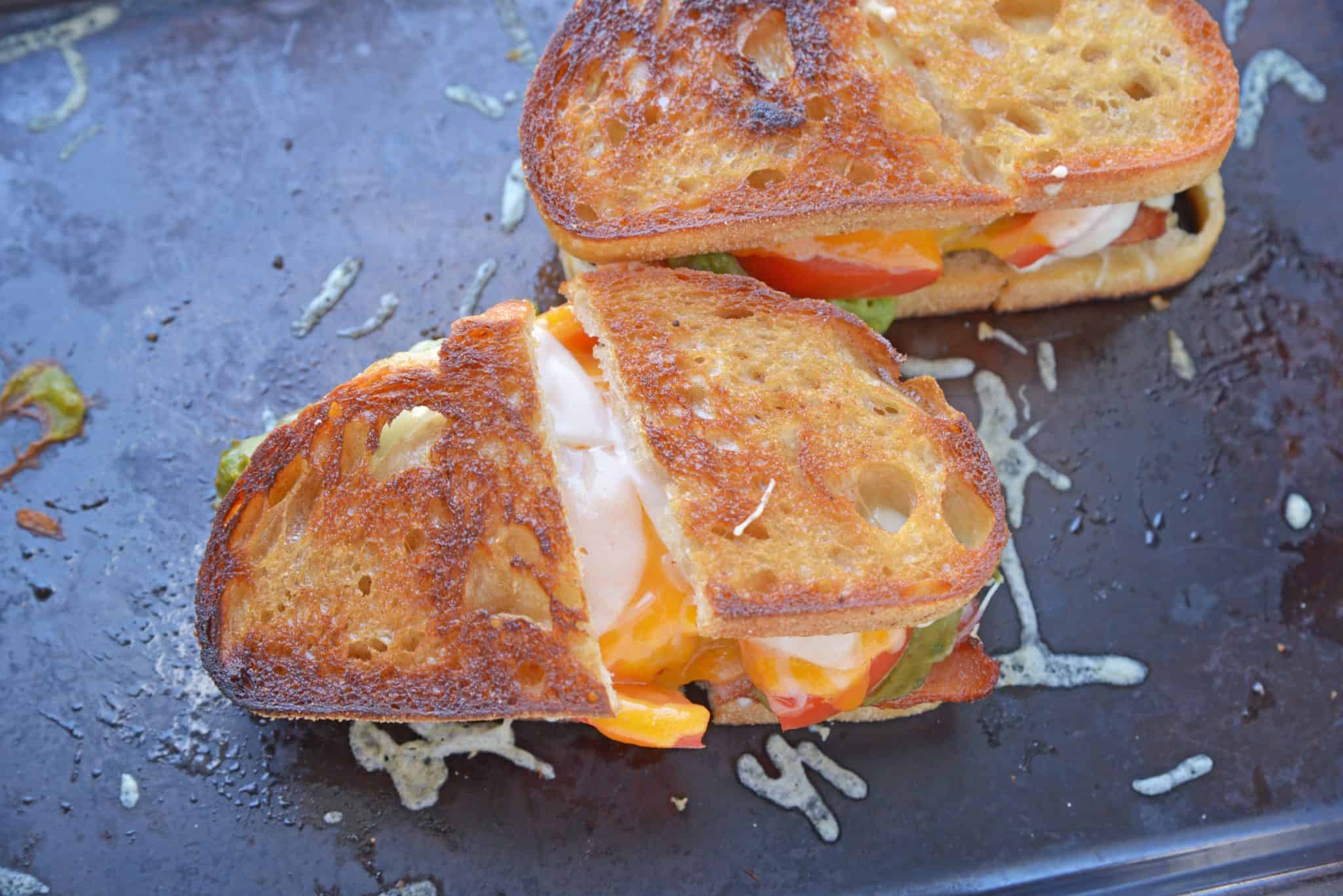 Bacon Avocado Grilled Cheese Sandwiches are made from a three cheese blend along with zesty guacamole, lime, and bacon, for out of this world sandwich experience! #howtomakegrilledcheese #gourmetgrilledcheese #avocadogrilledcheese www.savoryexperiments.com