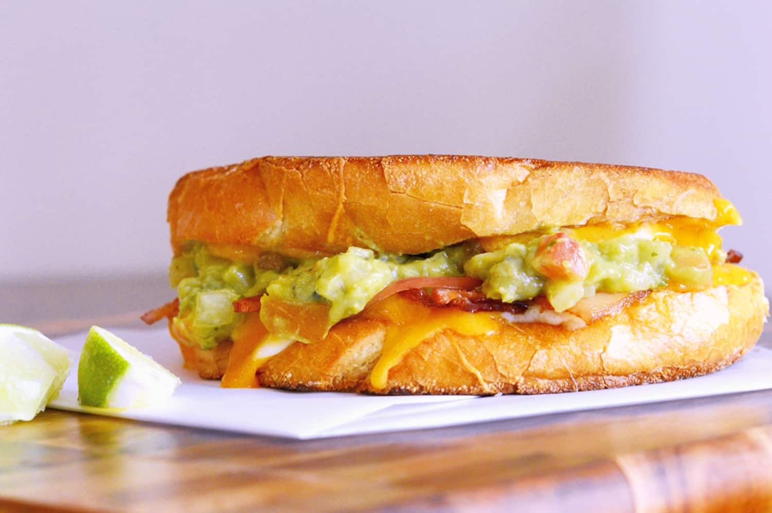 Bacon Avocado Grilled Cheese Sandwiches are made from a three cheese blend along with zesty guacamole, lime, and bacon, for out of this world sandwich experience! #howtomakegrilledcheese #gourmetgrilledcheese #avocadogrilledcheese www.savoryexperiments.com