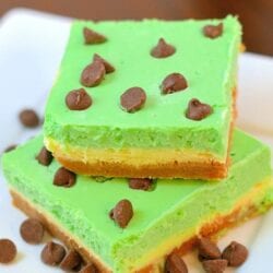 Grasshopper Cheesecake Bars are the perfect St Patrick's day dessert. Green and minty, they are easy to make and delicious to eat! #cheesecakebars #cheesecakebarsrecipe www.savoryexperiments.com