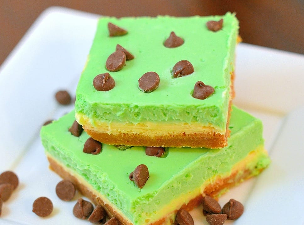 Grasshopper Cheesecake Bars are the perfect St Patrick's day dessert. Green and minty, they are easy to make and delicious to eat! #cheesecakebars #cheesecakebarsrecipe www.savoryexperiments.com