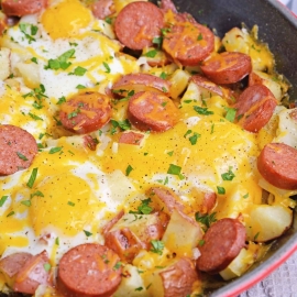 Sausage and Egg Skillet is a delicious breakfast skillet with andouille sausage, potato, eggs and gooey cheese. Ready in 30 minutes and perfect for special weekend brunch! #breakfastskilletrecipe #castironskilletrecipes www.savoryexperiments.com