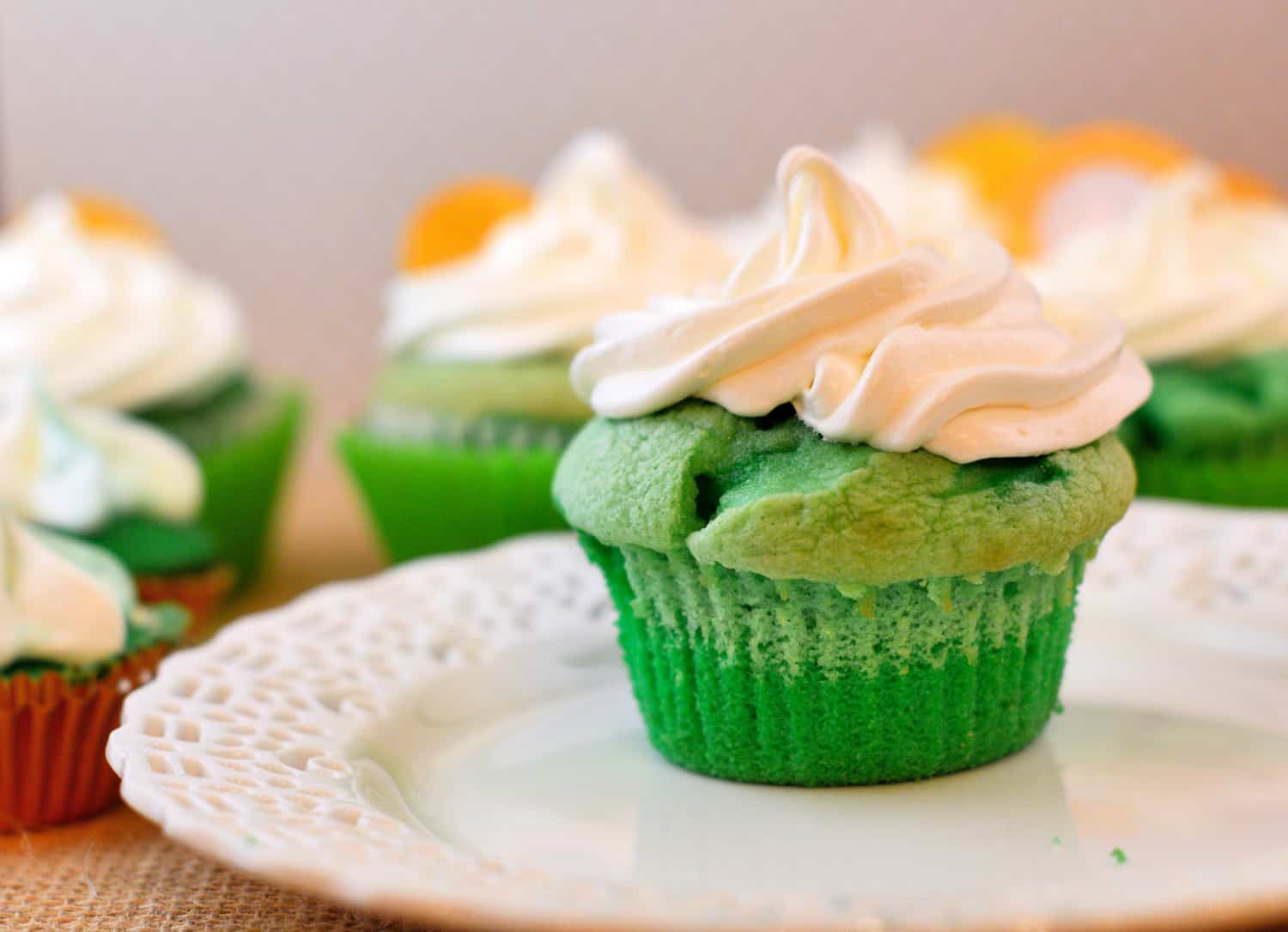 St. Patrick's Day Cupcakes in ombre style. Three shades of green and a whipped frosting. Perfect for your St. Patrick's Day Party! #stpatricksdaycupcakes #stpatricksdaydessert www.savoryexperiments.com