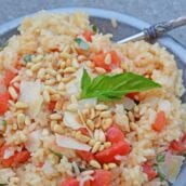 Tomato Parmesan Risotto is a creamy and delicious Italian style risotto recipe. Made with tomatoes, basil, garlic, pine nuts, and parmesan cheese! #risottorecipe #howtocookrisotto #parmesanrisotto www.savoryexperiments.com