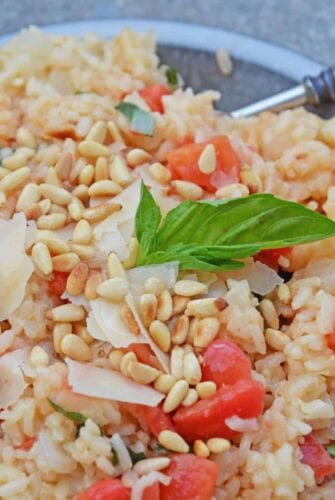 Tomato Parmesan Risotto is a creamy and delicious Italian style risotto recipe. Made with tomatoes, basil, garlic, pine nuts, and parmesan cheese! #risottorecipe #howtocookrisotto #parmesanrisotto www.savoryexperiments.com