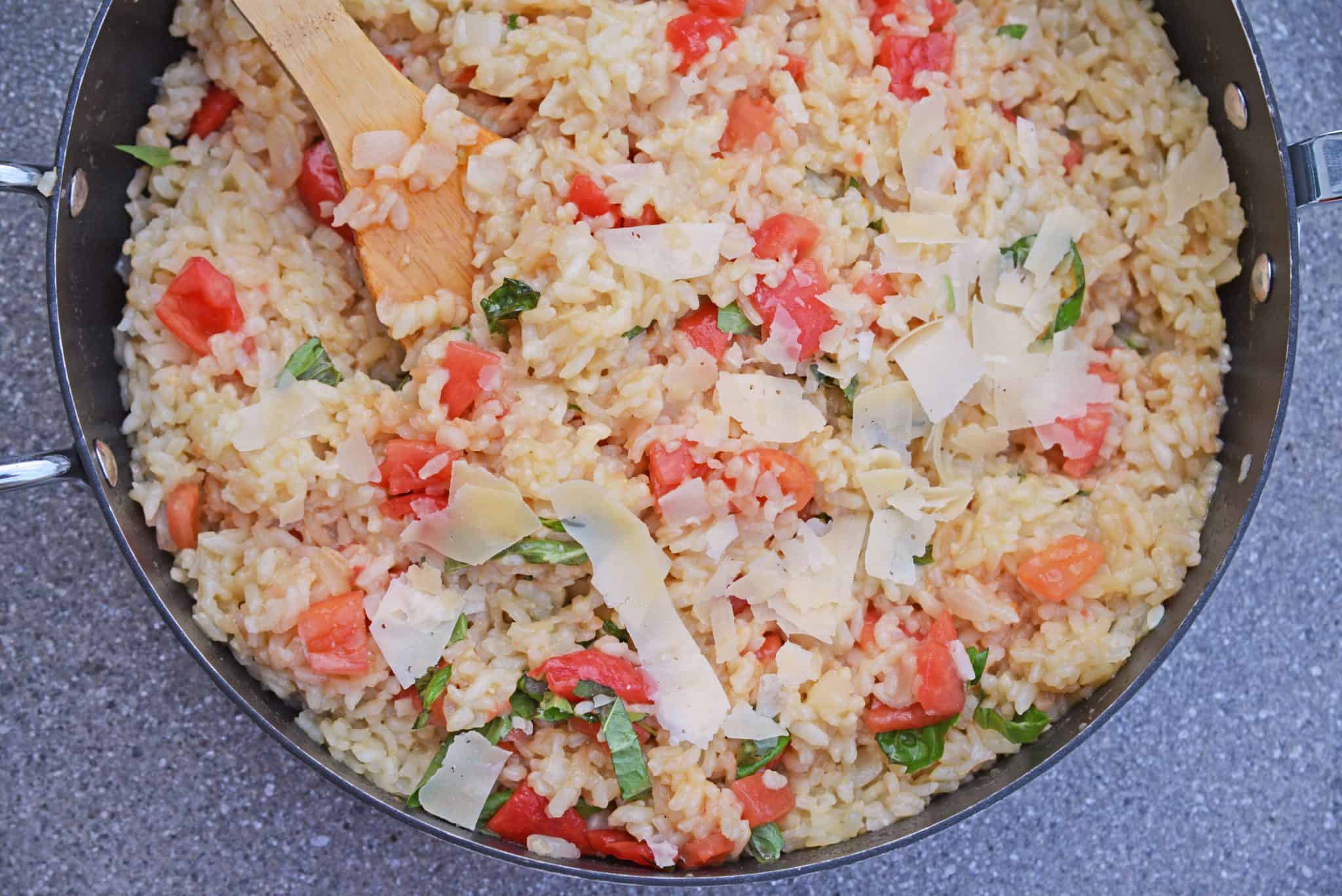 Tomato Parmesan Risotto is a creamy and delicious Italian style risotto recipe. Made with tomatoes, basil, garlic, pine nuts, and parmesan cheese! #risottorecipe #howtocookrisotto #parmesanrisotto www.savoryexperiments.com