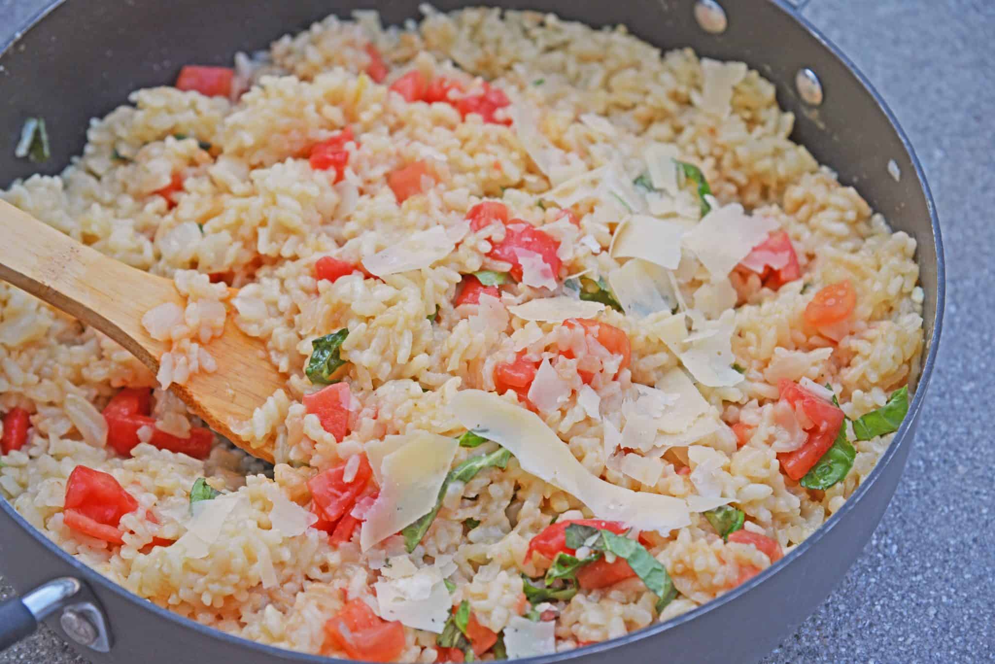 Tomato Parmesan Risotto is a creamy and delicious Italian style risotto recipe. Made with tomatoes, basil, garlic, pine nuts, and parmesan cheese! #risottorecipe #howtocookrisotto #parmesanrisotto www.savoryexperiments.com