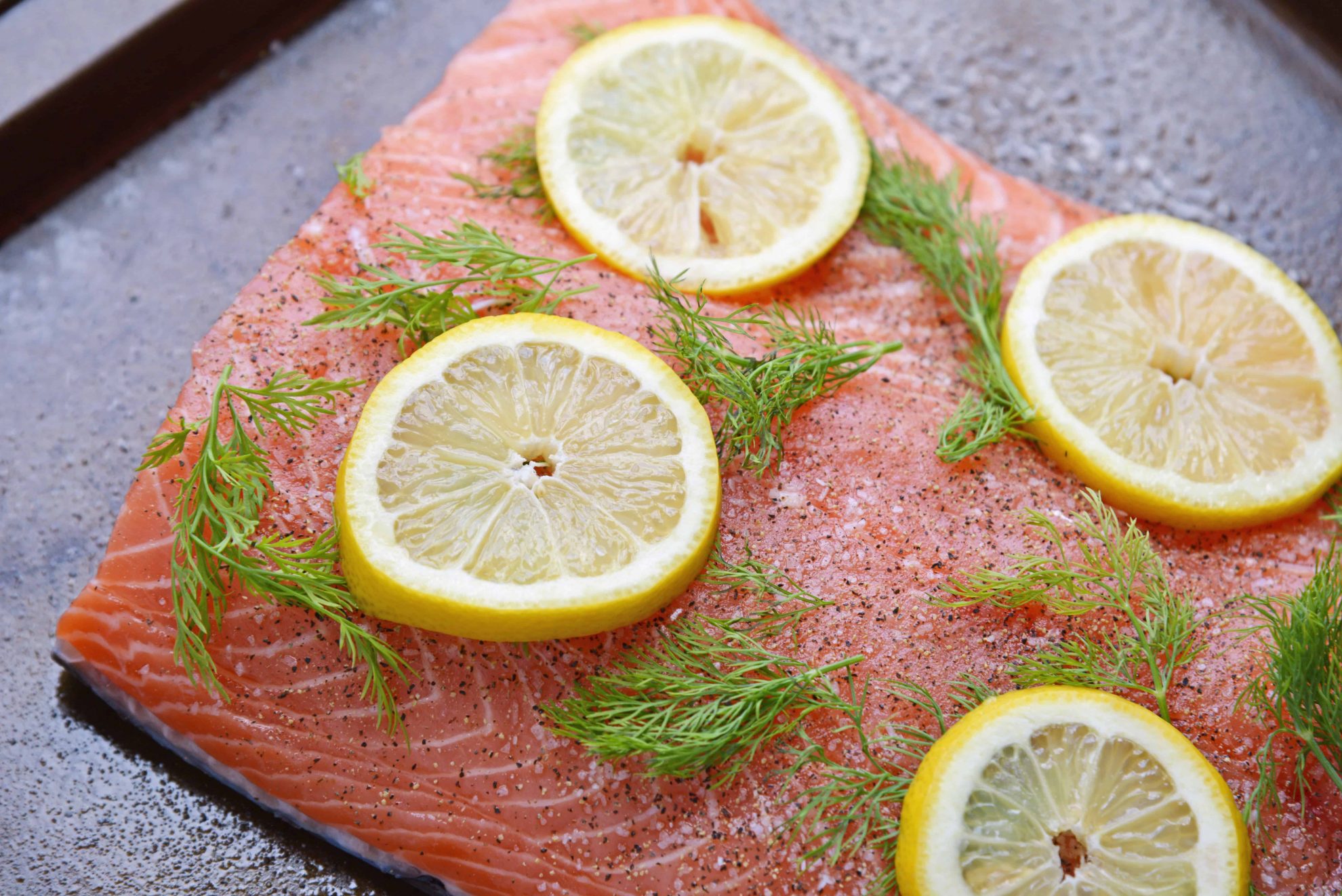 Raw salmon with fresh dill and lemons