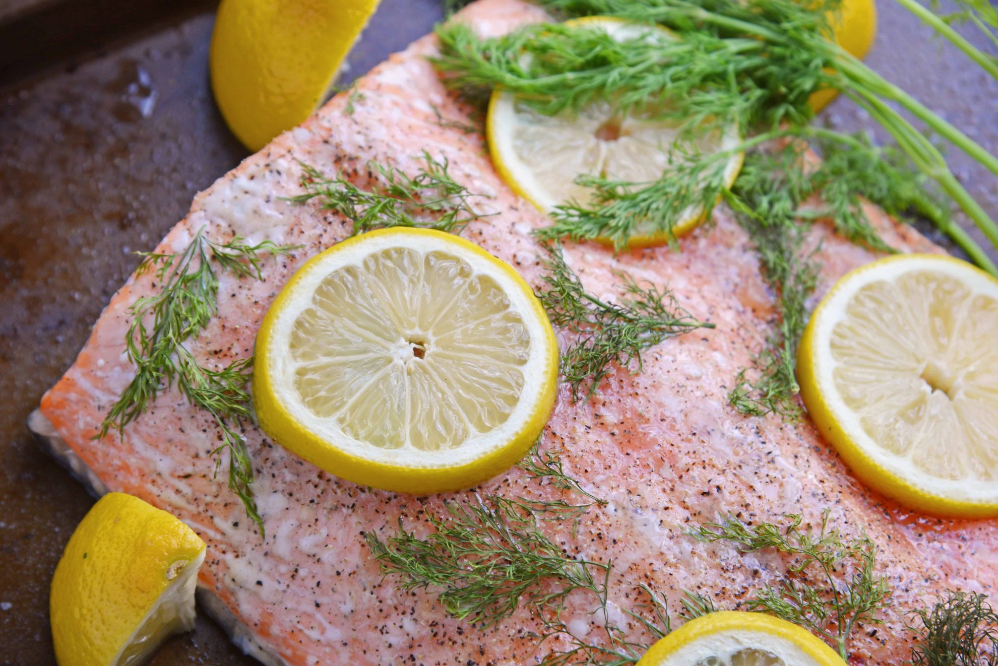 Healthy baked salmon with fresh lemons and dill