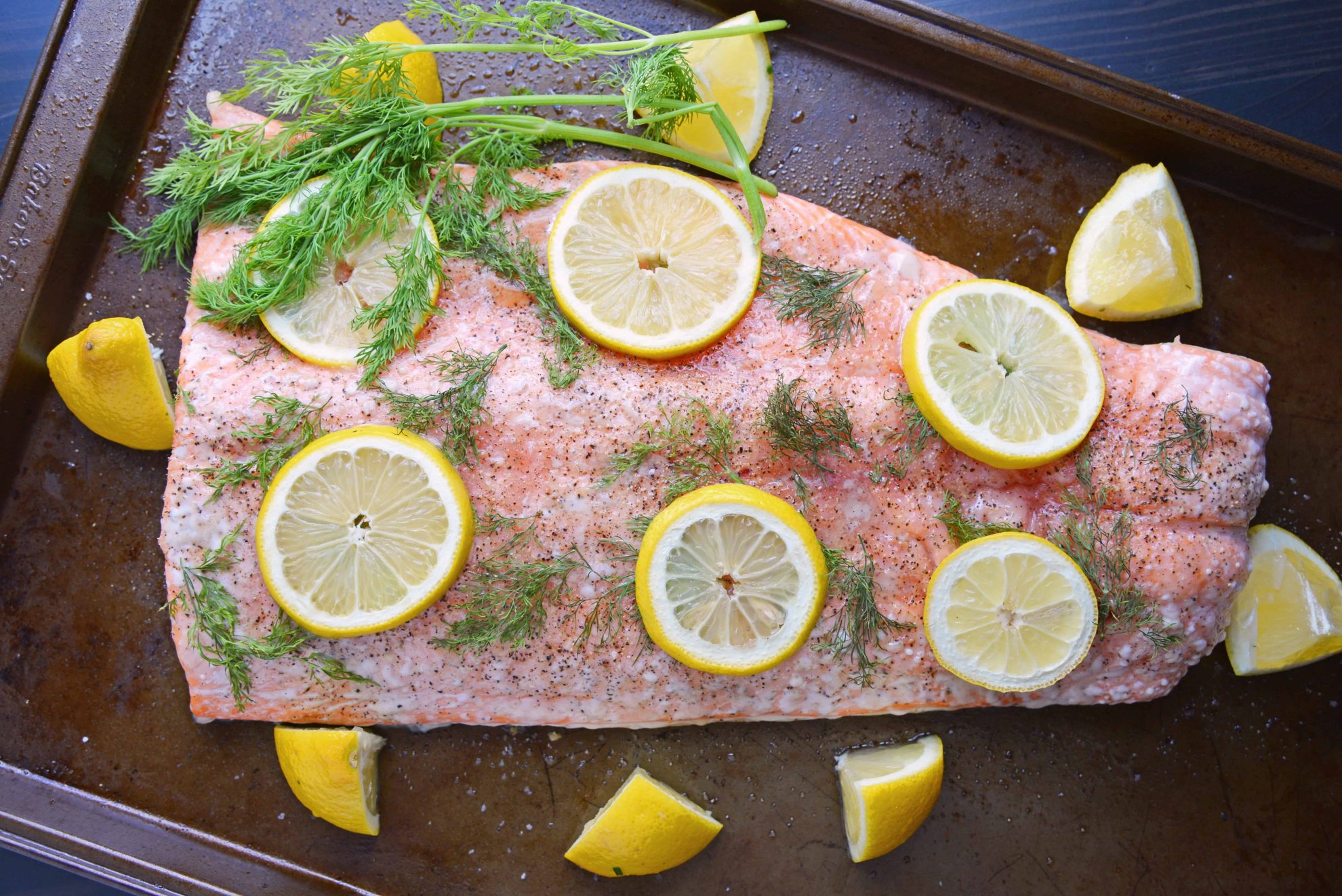 Overhead of whole salmon fillet with lemons and dill