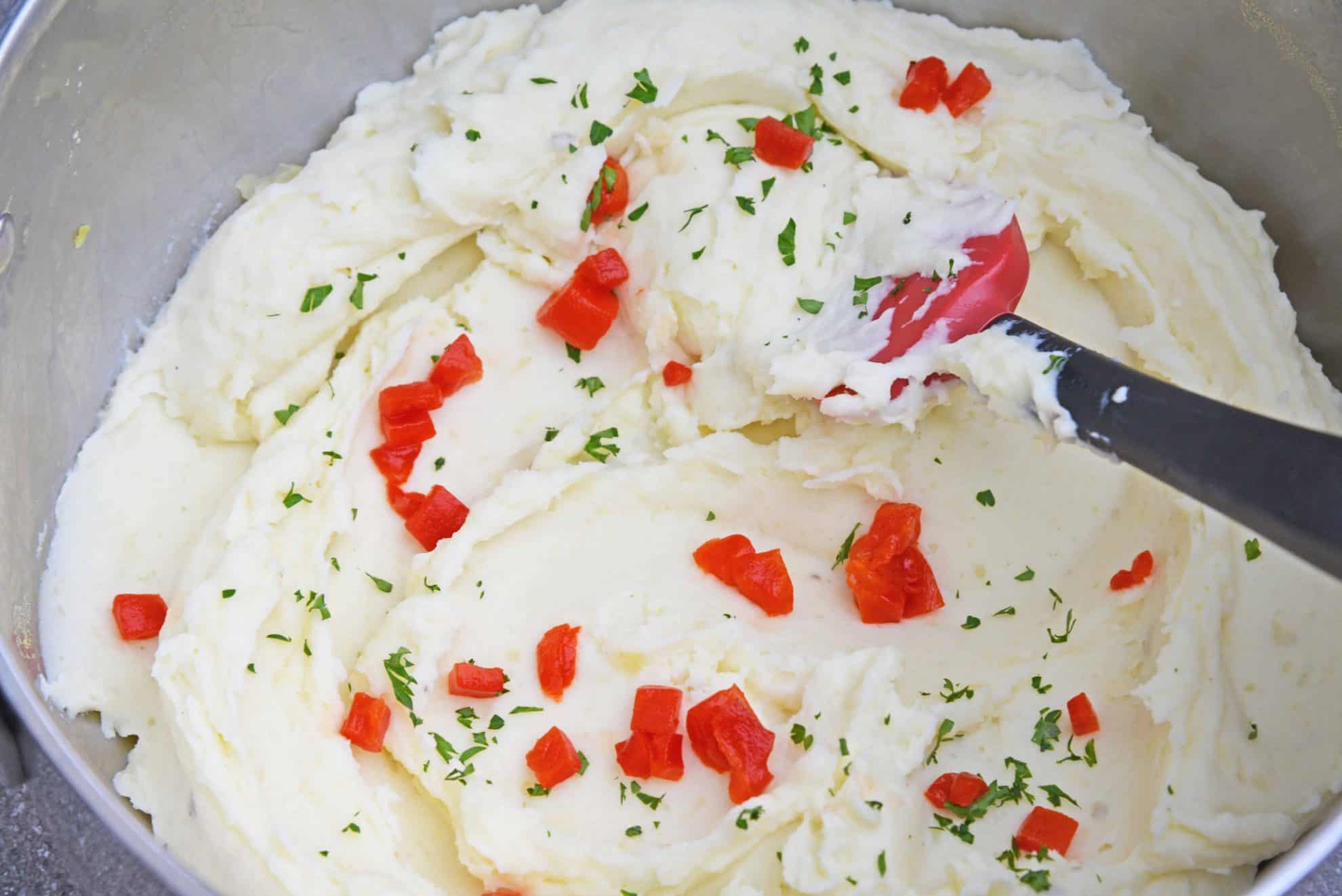 Mascarpone Mashed Potatoes take traditional mashed potatoes up a notch by adding creamy mascarpone and roasted red peppers! #howtomakemashedpotatoes #bestmashedpotatoes www.savoryexperiments.com