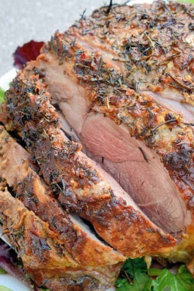 Leg of Lamb is an easy lamb recipe using a layer of fresh herbs and seasonings and high temperatures sear to form a nice crust leaving the instead nice and juicy. #legoflamb #roastlamb #easterlamb www.savoryexperiments.com