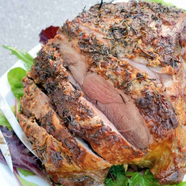 Leg of Lamb is an easy lamb recipe using a layer of fresh herbs and seasonings and high temperatures sear to form a nice crust leaving the instead nice and juicy. #legoflamb #roastlamb #easterlamb www.savoryexperiments.com