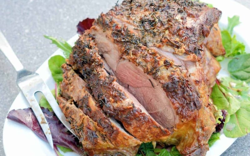 Leg of Lamb is an easy lamb recipe using a layer of fresh herbs and seasonings and high temperatures sear to form a nice crust leaving the instead nice and juicy. #legoflamb #roastlamb #easterlamb www.savoryexperiments.com
