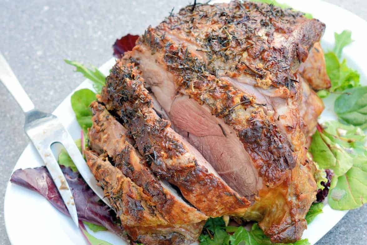 Leg of Lamb is an easy lamb recipe using a layer of fresh herbs and seasonings and high temperatures sear to form a nice crust leaving the instead nice and juicy. #legoflamb #roastlamb #easterlamb www.savoryexperiments.com