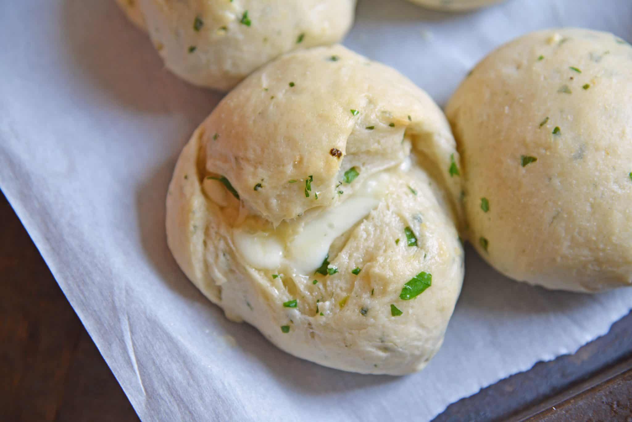 These Cheese Stuffed Garlic Rolls are delicious garlic and parsley rolls stuffed with gooey mozzarella cheese. Eat them plain or with a side of marinara.