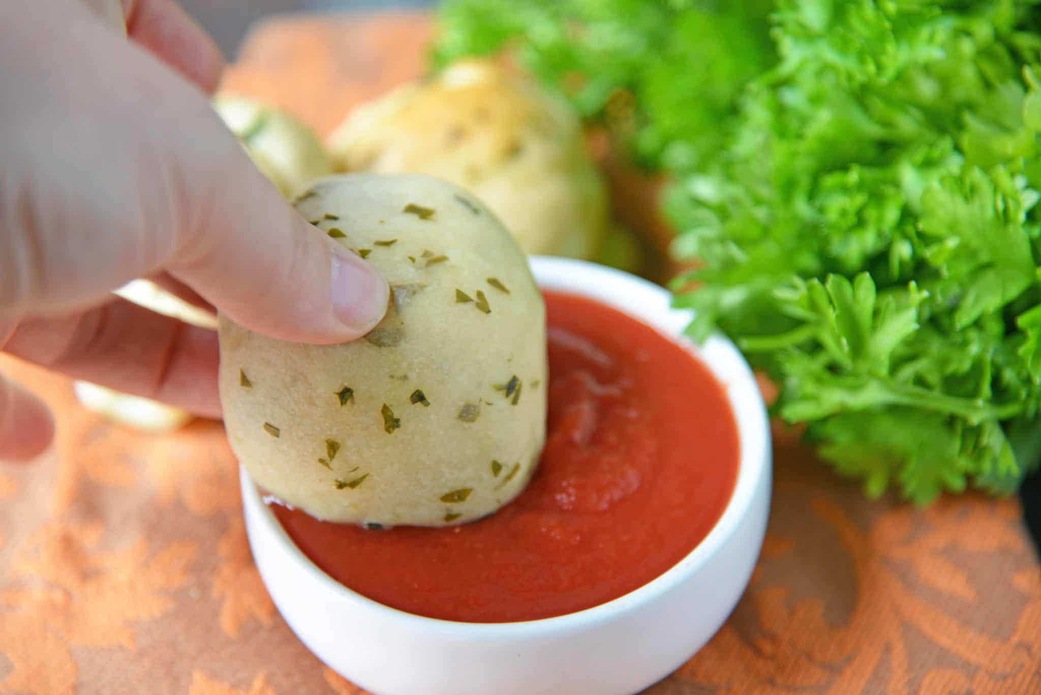 These Cheese Stuffed Garlic Rolls are delicious garlic and parsley rolls stuffed with gooey mozzarella cheese. Eat them plain or with a side of marinara. #cheesestuffedgarlicrolls #garlicrolls #mozzarella www.savoryexperiments.com