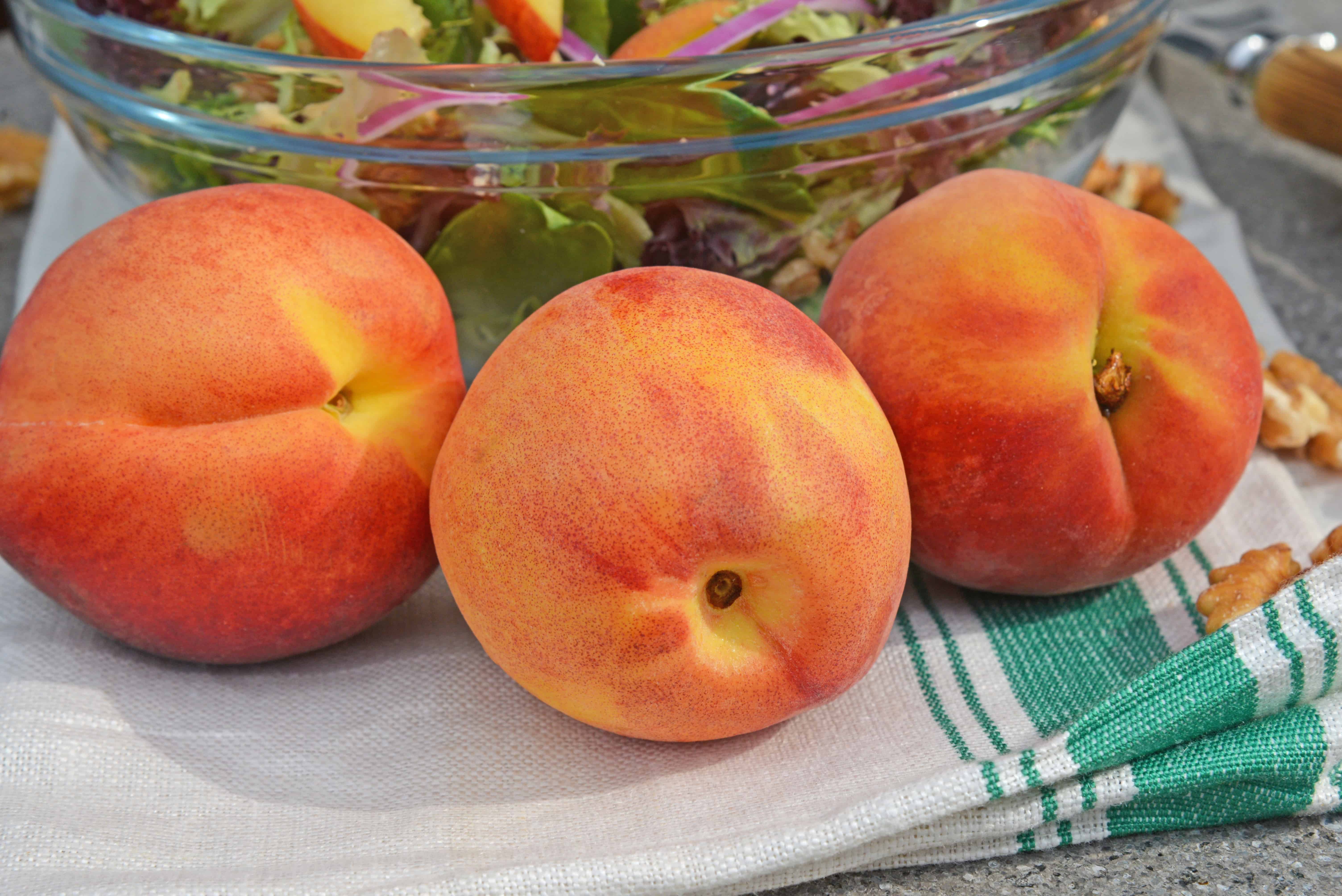 Peach Salad is a scrumptious summer salad filled with delicious peaches, gorgonzola cheese, shallots, candied walnuts and a tangy peach dressing. The perfect summer salad! #peachsalad #summersalads www.savoryexperiments.com