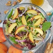 Peach Salad is a scrumptious summer salad filled with delicious peaches, gorgonzola cheese, shallots, candied walnuts and a tangy peach dressing. The perfect summer salad! #peachsalad #summersalads www.savoryexperiments.com