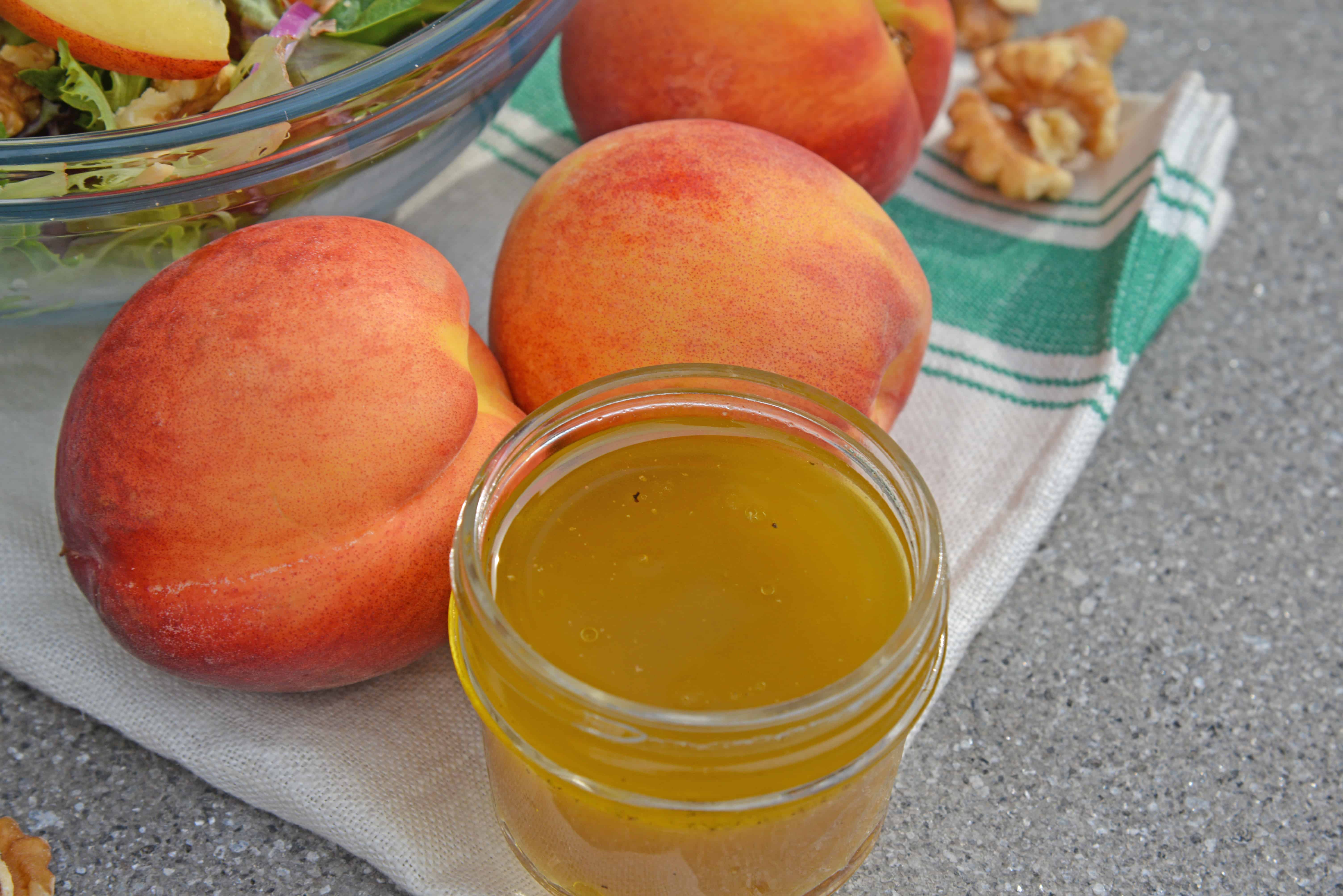 Peach Salad is a scrumptious summer salad filled with delicious peaches, gorgonzola cheese, shallots, candied walnuts and a tangy peach dressing. The perfect summer salad! #peachsalad #summersalads www.savoryexperiments.com