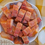 Candied bacon is the best sweet and salty snack with a kick. Serve as strips or bites, bacon is caramelized with brown sugar and and a touch of heat. #candiedbacon #pigcandy #brownsugarbacon www.savoryexperiments.com
