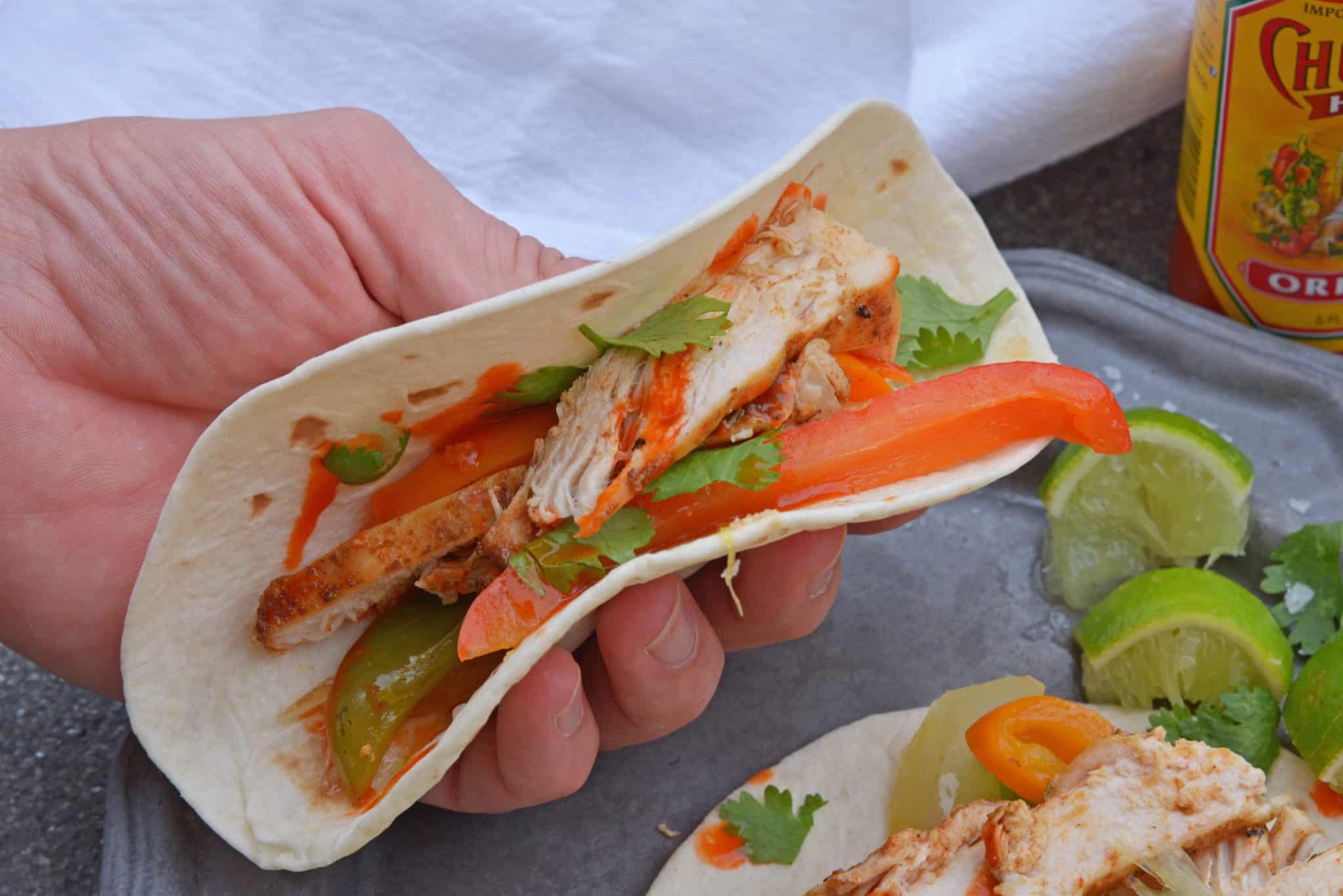 My Grilled Chicken Fajitas are a simple and healthy meal that you can have ready in under 30 minutes and make for the perfect weeknight meal.  #grilledchickenfajitas #fajitas #grilledchicken www.savoryexperiments.com