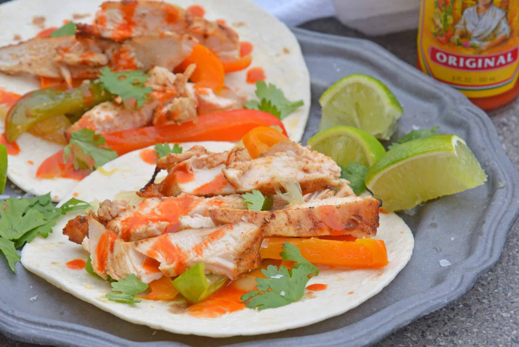 My Grilled Chicken Fajitas are a simple and healthy meal that you can have ready in under 30 minutes and make for the perfect weeknight meal.  #grilledchickenfajitas #fajitas #grilledchicken www.savoryexperiments.com