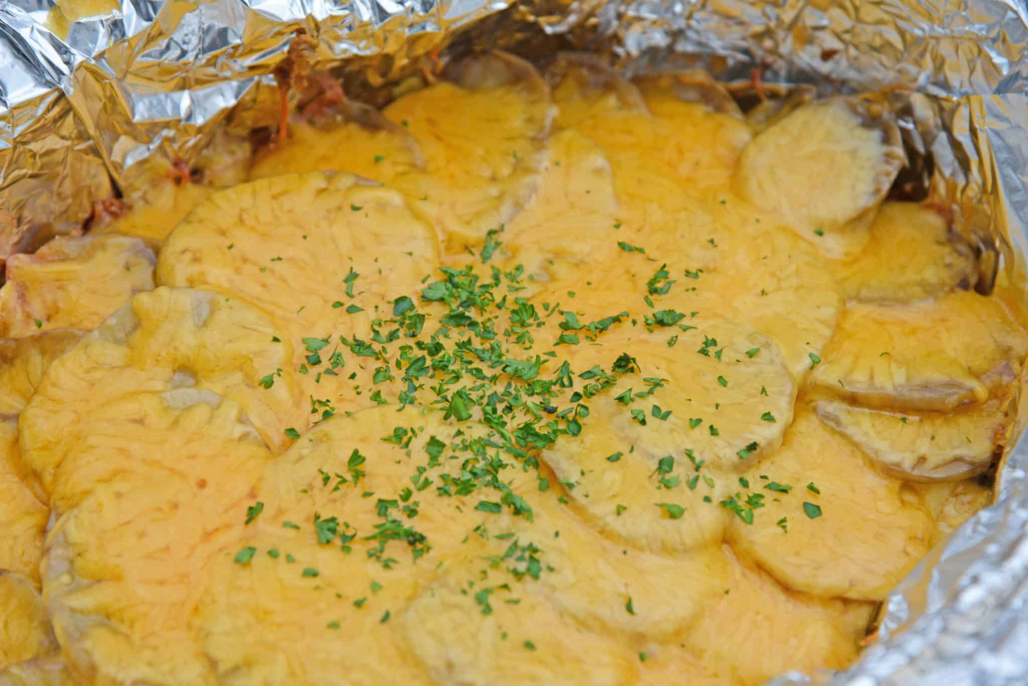 Slow Cooker Potatoes au Gratin are an amazing copycat recipe of Fleming's Steakhouse's potatoes.  Pop it in your slow cooker and reap the cheesy benefits. #slowcookerpotatoesaugratin #potatoesaugratin www.savoryexperiments.com