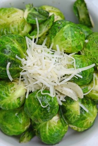Garlic Butter Brussels Sprouts is an easy side dish that even sprout haters will love! Fresh brussel sprouts covered in butter, garlic, and topped with parmesan cheese. #brusselssproutsrecipes #garlicbutter www.savoryexperiments.com