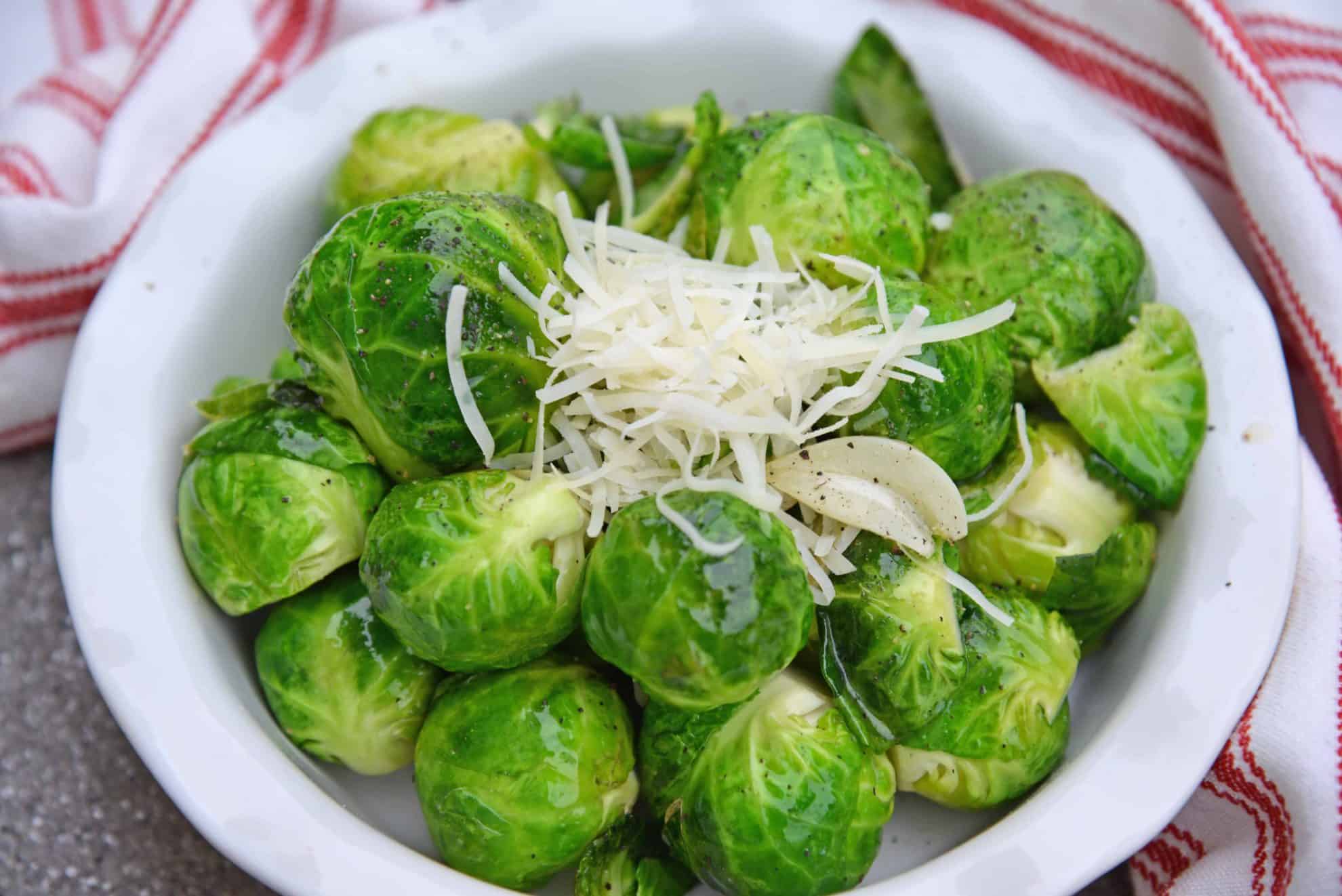 Garlic Butter Brussels Sprouts is an easy side dish that even sprout haters will love! Fresh brussel sprouts covered in butter, garlic, and topped with parmesan cheese. #brusselssproutsrecipes #garlicbutter www.savoryexperiments.com