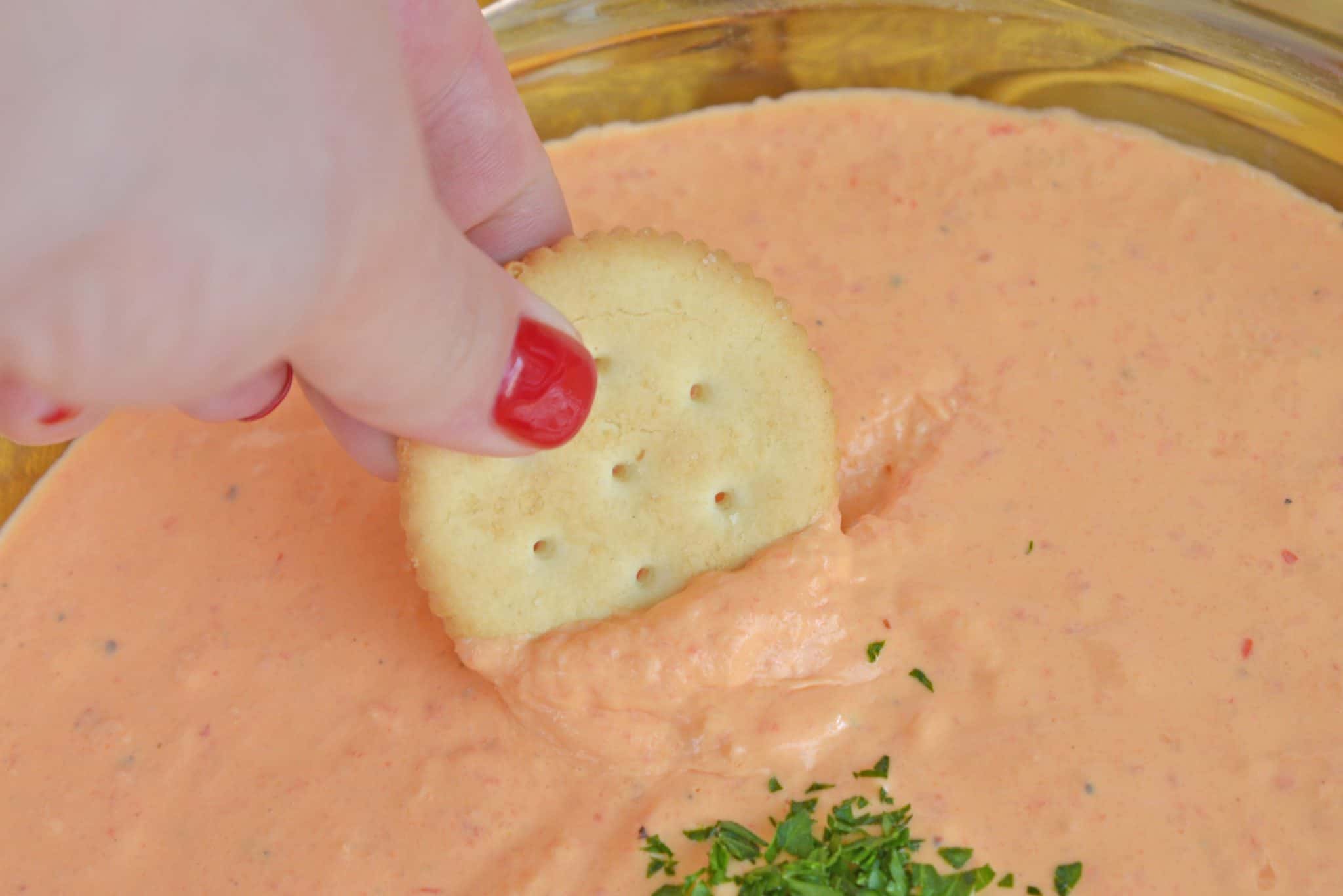 Roasted Red Pepper Dip is tangy, light, and irresistibly delicious. Served warm or cold, it is perfect for parties or an afternoon snack. #roastedredpepperdip #chipdip #roastedredpepper www.savoryexperiments.com