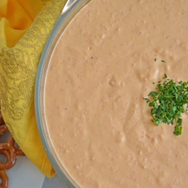 overhead view of roasted red pepper dip garnished with parsley