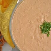 Roasted Red Pepper Dip is tangy, light, and irresistibly delicious. Served warm or cold, it is perfect for parties or an afternoon snack. #roastedredpepperdip #chipdip #roastedredpepper www.savoryexperiments.com