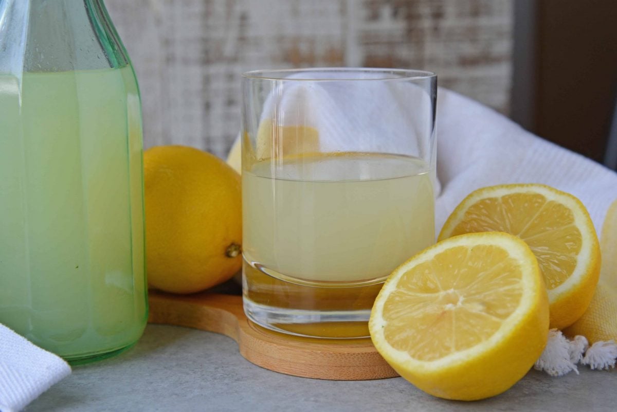 limoncello in a small glass with fresh lemons 