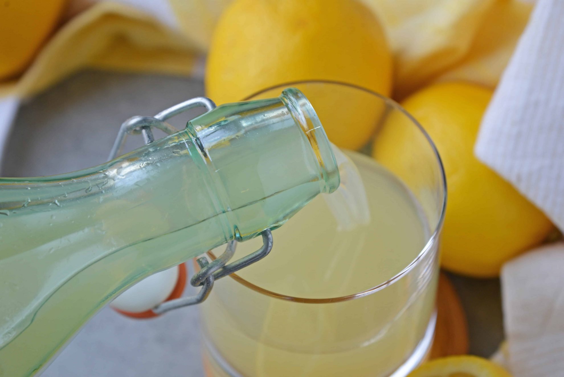 pouring limoncello into a glass 