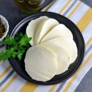Homemade Mozzarella Cheese is a mix of science and cooking. With a velvety texture and packed with flavor, you will be making it all the time. #homemademozzarellacheese #mozzarella #cheese www.savoryexperiments.com