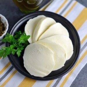 Homemade Mozzarella Cheese is a mix of science and cooking. With a velvety texture and packed with flavor, you will be making it all the time. #homemademozzarellacheese #mozzarella #cheese www.savoryexperiments.com