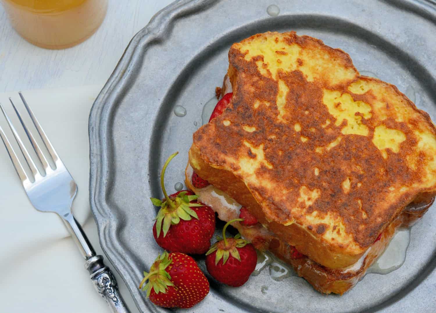 Strawberry Stuffed French Toast is made with mascarpone, Dutch honey syrup, fresh strawberries, and buttery brioche, pound cake, or angel food, for a perfectly delicious dish to enjoy for breakfast! #stuffedfrenchtoast www.savoryexperiments.com