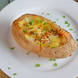 Stuffed Breakfast Potato on a plate topped with chives