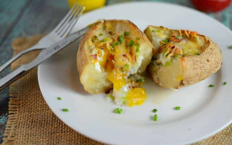Stuffed Breakfast Potato on a white plate cut in half