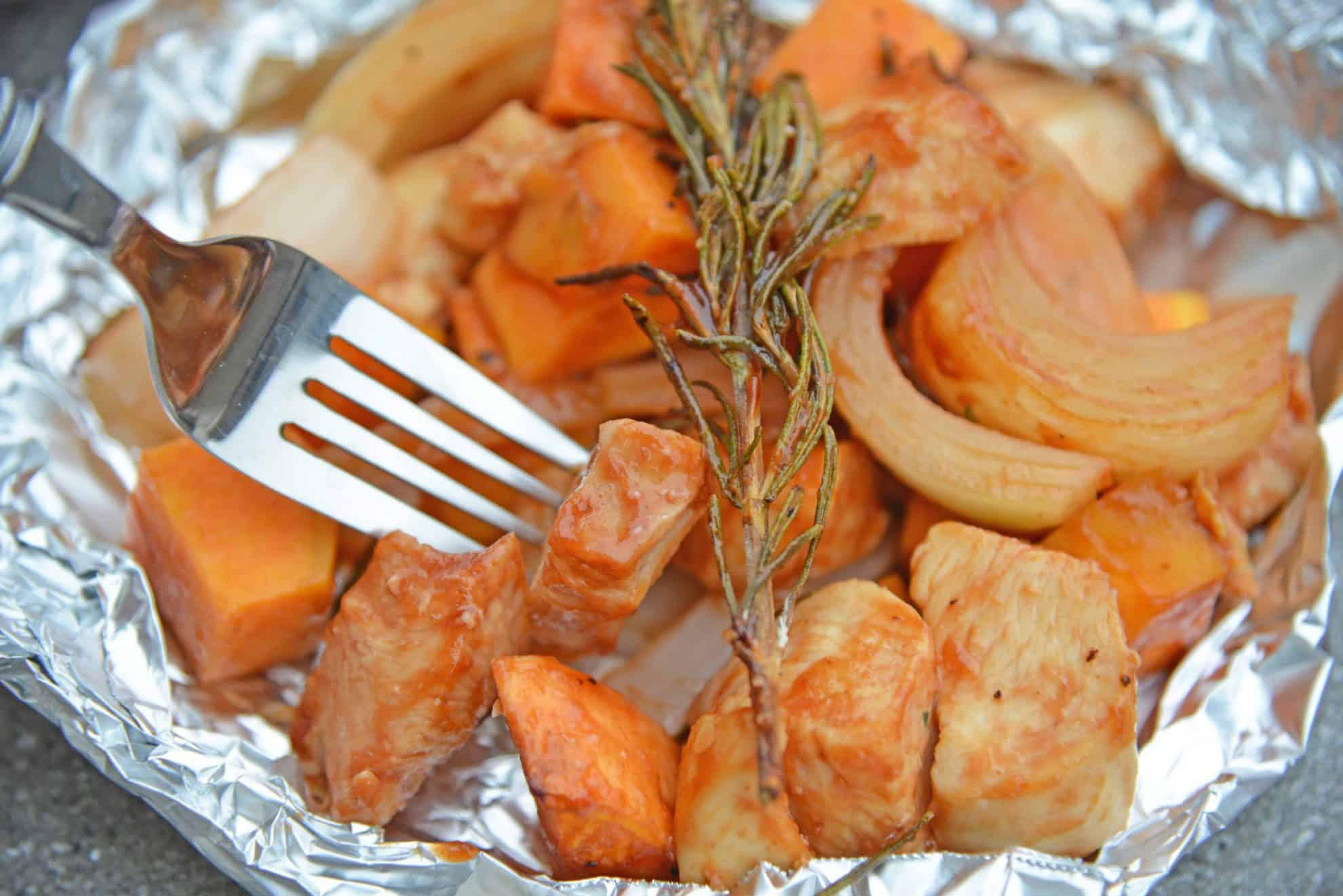 This BBQ Chicken Hobo Dinner is a great dinner option for families on the go. These chicken foil packets are packed full of flavor for a weeknight meal! #hobodinner #chickenfoilpackets #hobopackets www.savoryexperiments.com