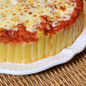 Baked Ziti Pie is a new twist on an old classic. Ziti smothered in marinara and cheese, but in pie form! Make with a side of Italian sausage or meatballs. #bakedzitirecipes #howtomakebakedziti www.savoryexperiments.com
