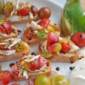 Crab Bruschetta is a mound of fresh tomatoes, garlic basil and buttery crab meat piled high on crispy toast. This is one of the best appetizers out there! #crabbruschetta #easybruschetta www.savoryexperiments.com